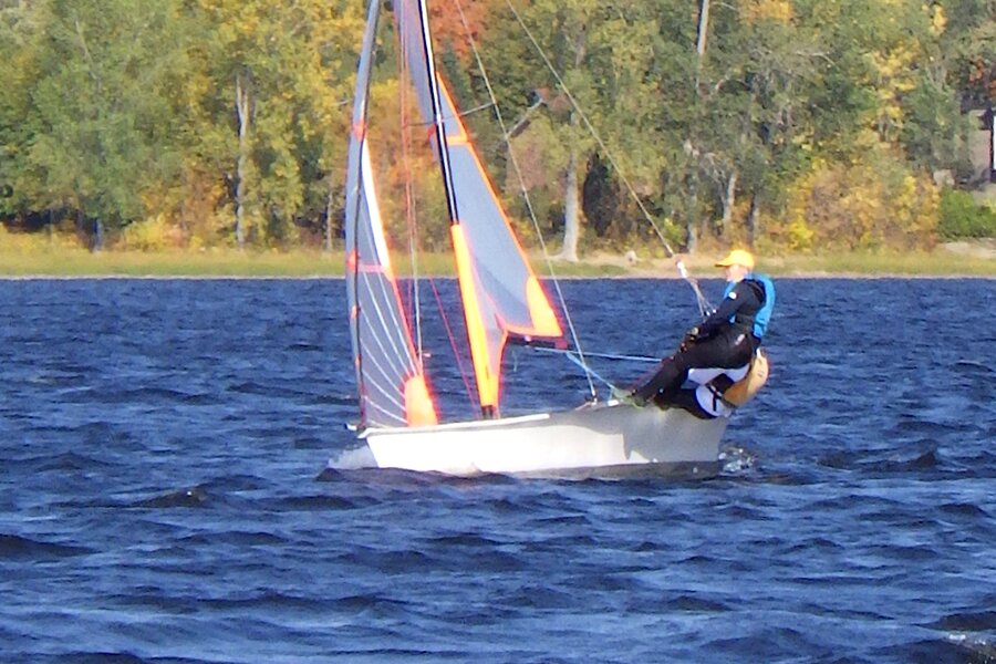 A two-person 29er skiff sailing upwind, hull visible