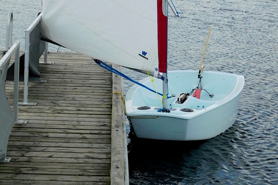 An Optimist dinghy under sail